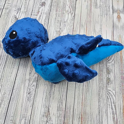 Side view of blue bumpy nessie plush