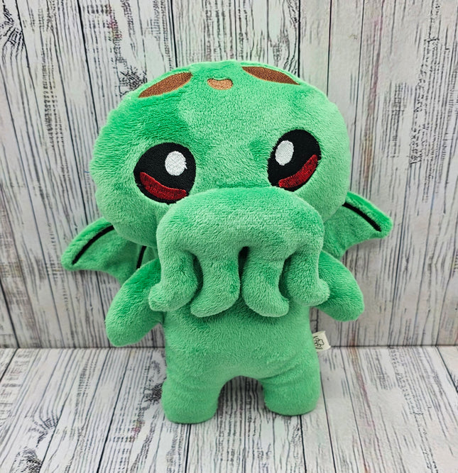 image of plush Cthulhu propped up against a wooden background