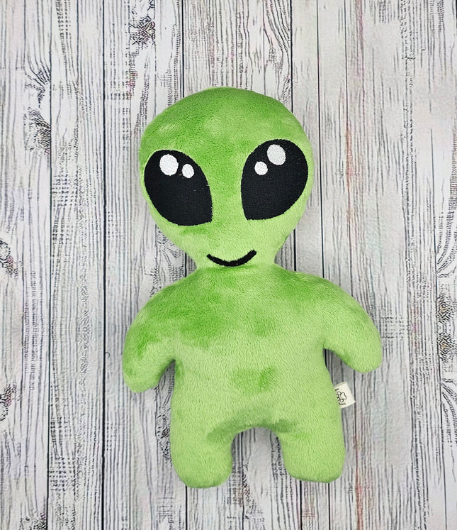 image of the front of the lime green alien plush with big kawaii embroidered eyes