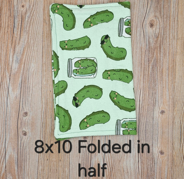 image of folded 8x10 flannel towel with pickles on a light blue background