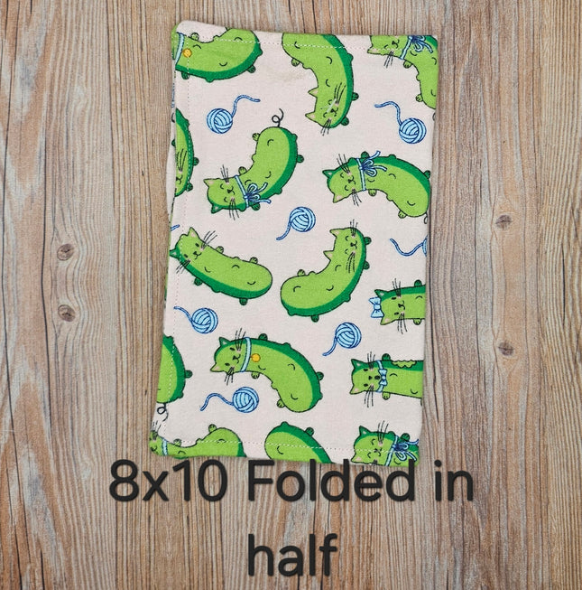image of folded 8x10 flannel towel with cat pickles on a light pink background