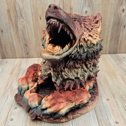 image of 3d printed dire wolf dice tower showing the red, black, and gold gradient when printed. The wolf has more red and brown tones in this particular print. 