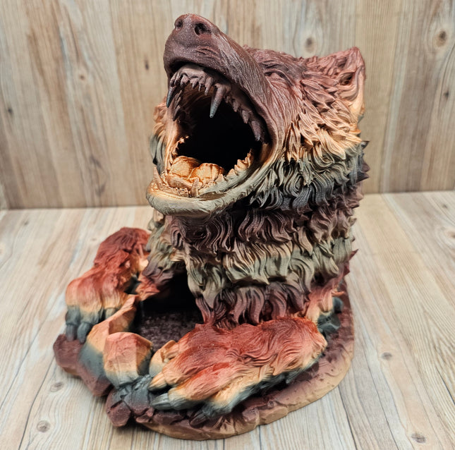 image of 3d printed dire wolf dice tower showing the red, black, and gold gradient when printed. The wolf has more red and brown tones in this particular print. 