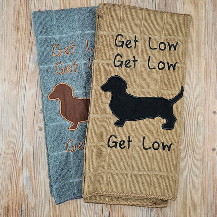 main image of embroidered polyester kitchen towels. They say "Get Low" 3 times and have a dachshund silhouette 