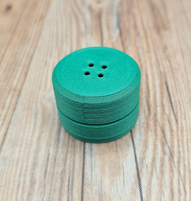 image of green compact scent vessel
