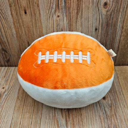 image of plush football dog toy in orange/white with embroidered laces
