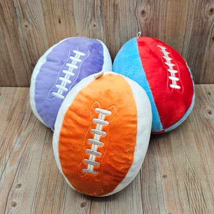 image of 3 plush football dog toys in orange/white, purple/white, and red/blue with embroidered laces