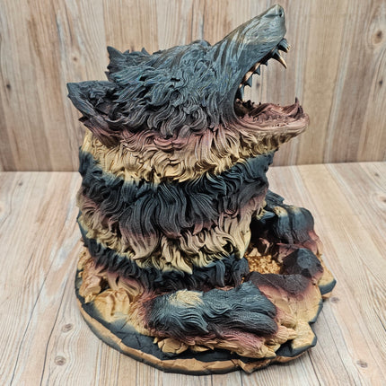 side view of 3d printed dire wolf dice tower showing the red, black, and gold gradient when printed. The wolf has more black and gold tones in this particular print. 