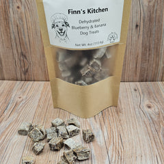 Bag of Finn's Kitchen dehydrated blueberry and banana dog treats on a wooden surface
