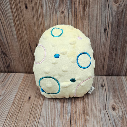 yellow plush easter egg dog toy with embroidered circles 