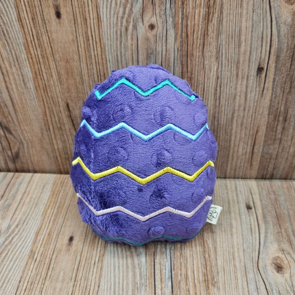 purple plush easter egg dog toy with embroidered zigzag design