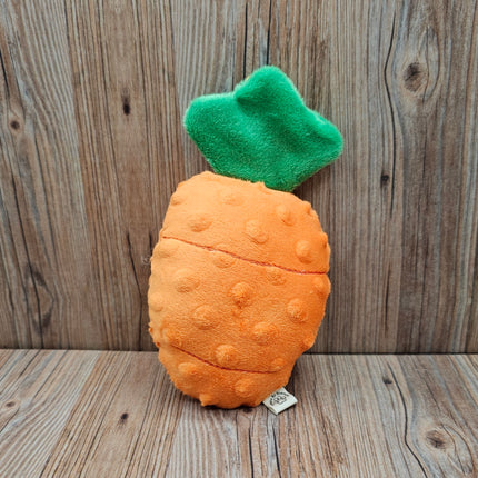 Plush carrot dog toy with a green top