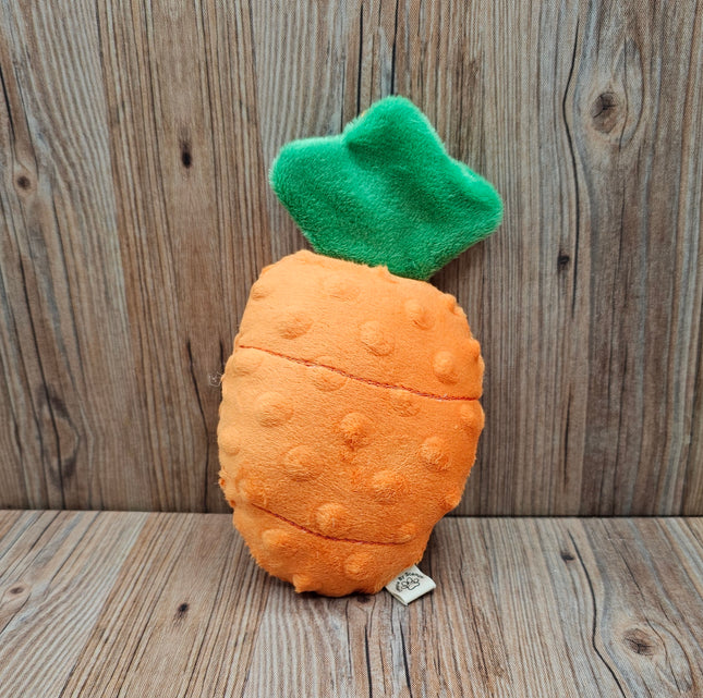 Plush carrot dog toy with a green top