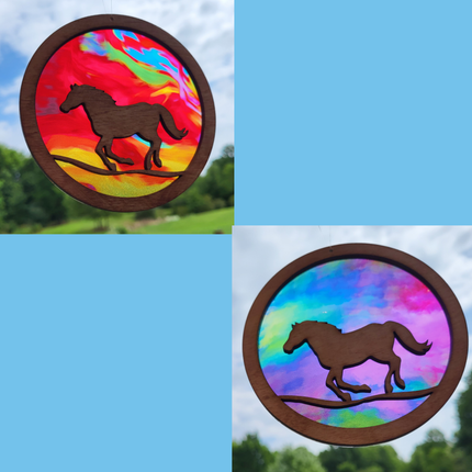 Circular, wooden suncatchers with a horse running. Transparent acrylic background with multi colored "fire" or rainbow colored backgrounds.
