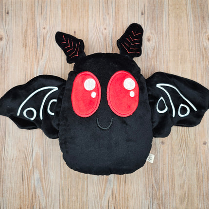 Cute mothman plush with embroidered red eyes and soft black wings.