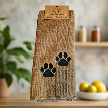 100% polyester, tan kitchen towel with 2 embroidered black paw prints