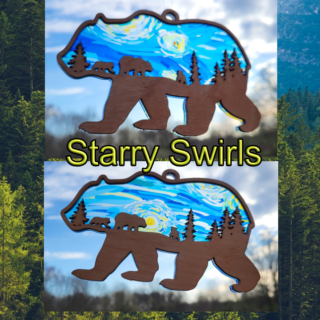 image of a wooden suncatcher in the shape of a bear walking. The inner area has been laser cut and shows smaller bears and pine trees. the transparent acrylic background shows a "starry swirl" image.