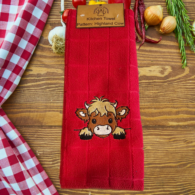 image of a red embroidered polyester kitchen towel with a cute highland cow