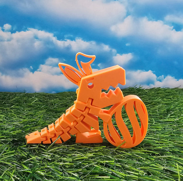 An orange 3d printed Easter Dinosaur holding an egg. 