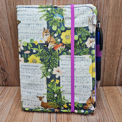 notebook with wildlife and hymnal pages on fabric